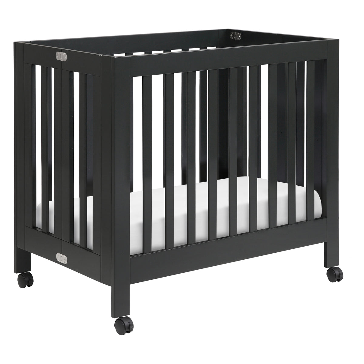 Three quarter view of Origami Mini Crib in Black showcasing vertical slats, folding hinges, and caster wheels against a white background