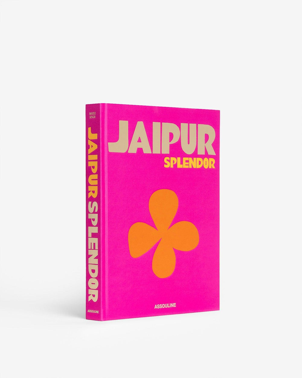 Three-quarter view of Jaipur Splendor hardcover book showing bright pink silk cover with gold title and orange flower motif on white background