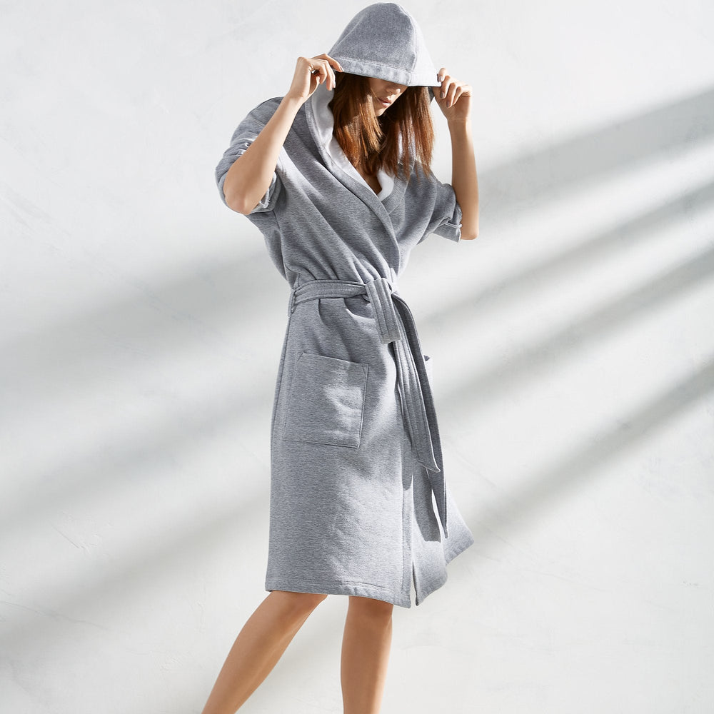 Three-quarter view of Jersey Knit Hooded Robe on model, hood up, belted waist and front patch pockets