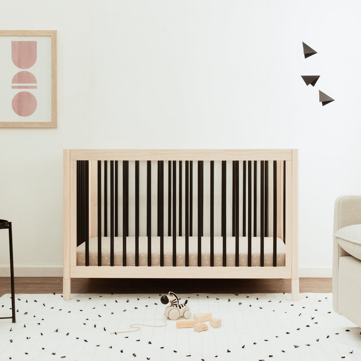 Front view of Gelato 4-in-1 convertible crib showcasing washed natural finish and contrasting dark slats in a nursery