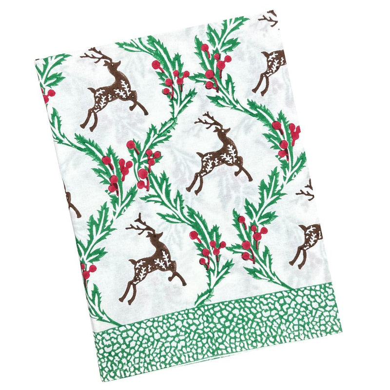 Christmas-themed tablecloth with reindeer and holly design on a white background