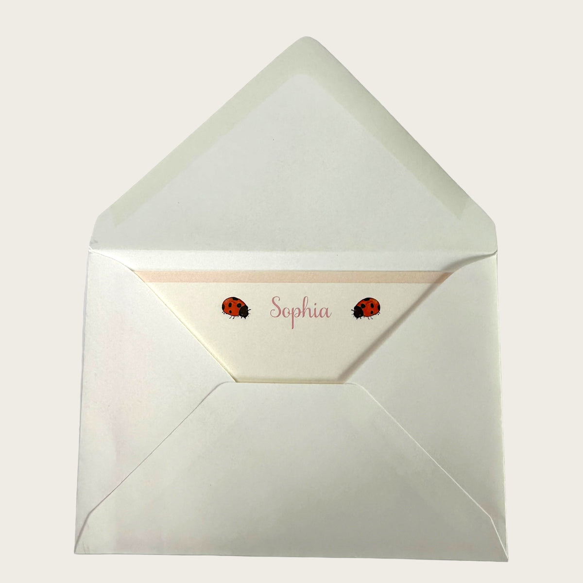 Top view of Ladybird notecard envelope showing personalized name Sophia and two ladybird illustrations on the flap
