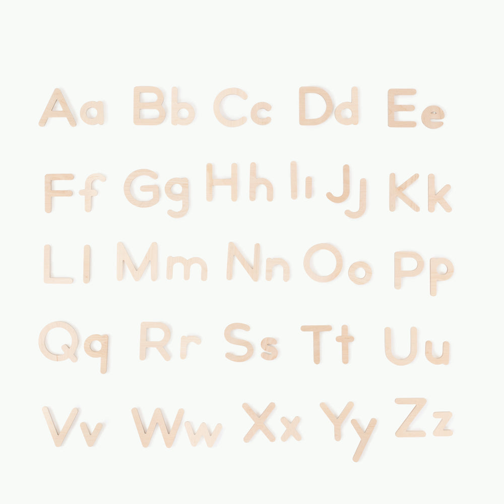Top-down view of children’s wooden letters in birch showing uppercase and lowercase letters on a white background