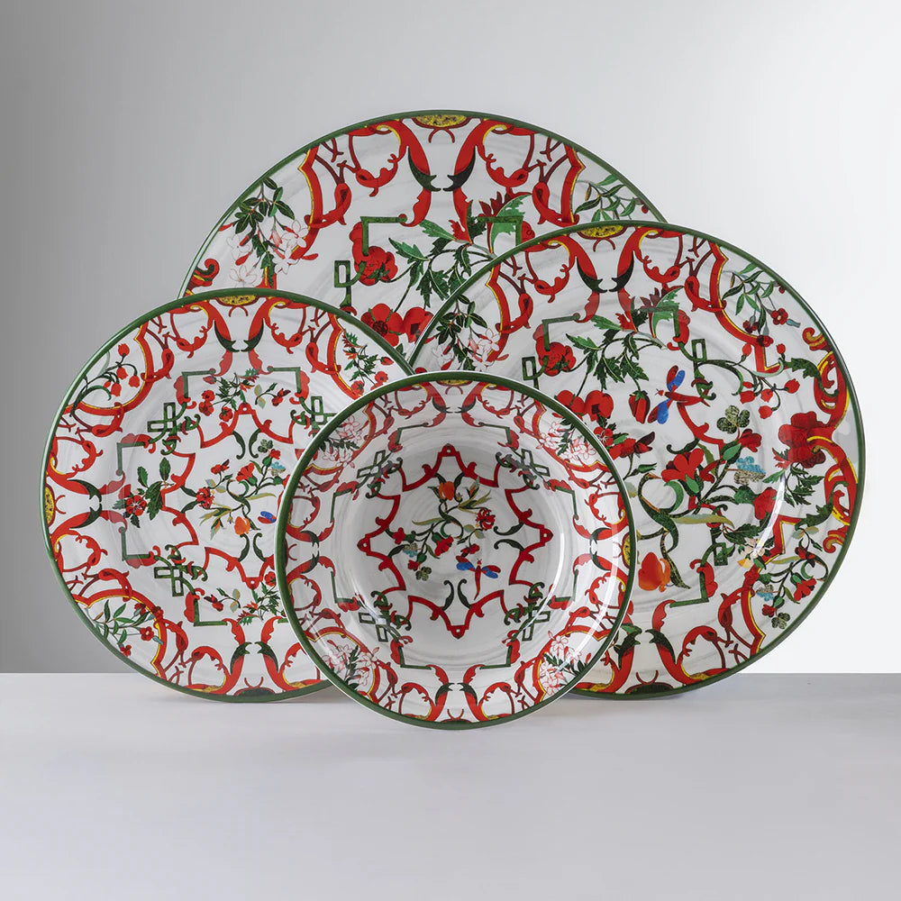 Front view of Lillybet melamine bowl with matching plates showing red and green floral scroll pattern on white background