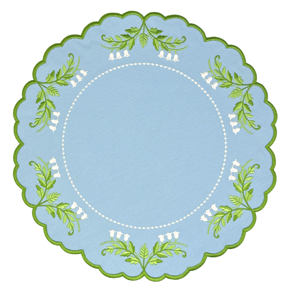 Top view of Tilly placemat with hand embroidered lily of the valley and green leaf embroidery on light blue scalloped edge