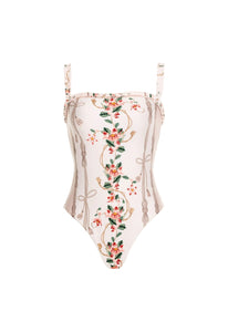 Front view of Limón Navegante One-Piece showcasing ruffled square neckline and floral embroidery on white background