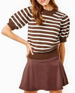 Model is wearing the Locust Active Sweater in Chocolate/ Off White Stripe with the Flounce Skort in Chocolate