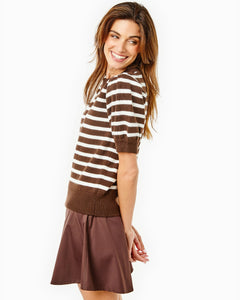 Model is wearing the Locust Active Sweater in Chocolate/ Off White Stripe with the Flounce Skort in Chocolate