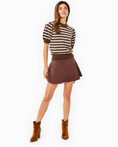 Model is wearing the Locust Active Sweater in Chocolate/ Off White Stripe with the Flounce Skort in Chocolate