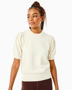 Model is wearing the Locust Active Sweater in Cream with the University Flare Pants in Chocolate