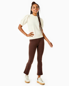 Model is wearing the Locust Active Sweater in Cream with the University Flare Pants in Chocolate