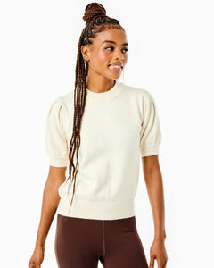 Model is wearing the Locust Active Sweater in Cream with the University Flare Pants in Chocolate