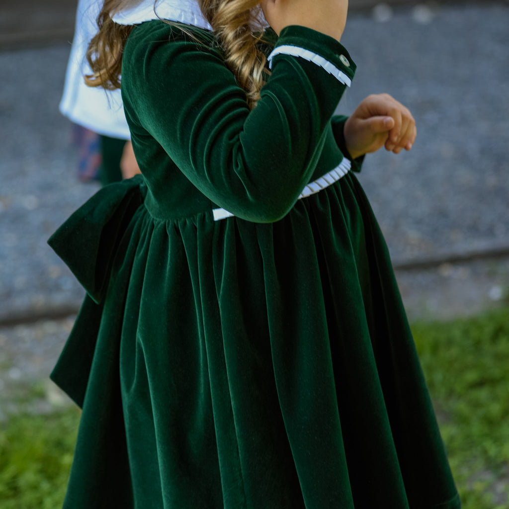 Baby girls’ Long Sleeve Grace Bubble in Grafton Green Velvet with a white pleated collar, waist and cuff trim.