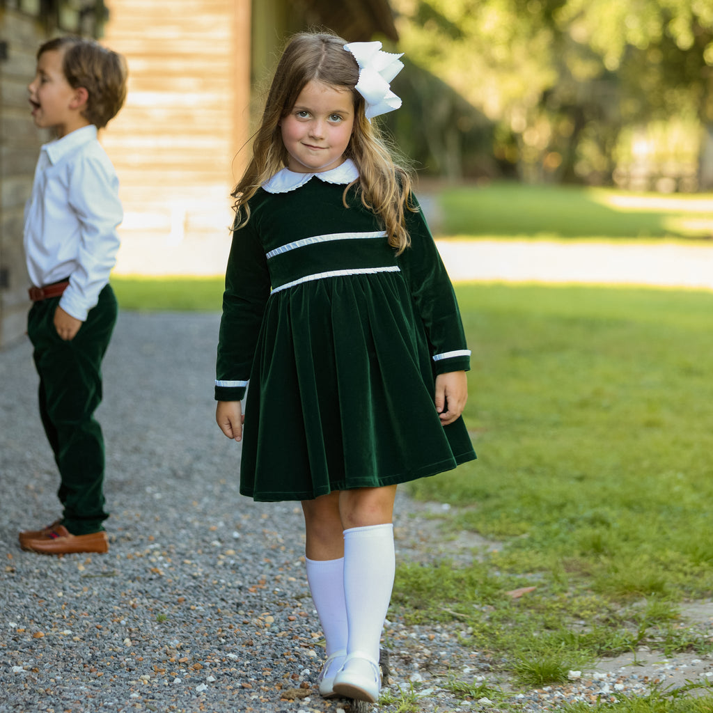 Baby girls’ Long Sleeve Grace Bubble in Grafton Green Velvet with a white pleated collar, waist and cuff trim.