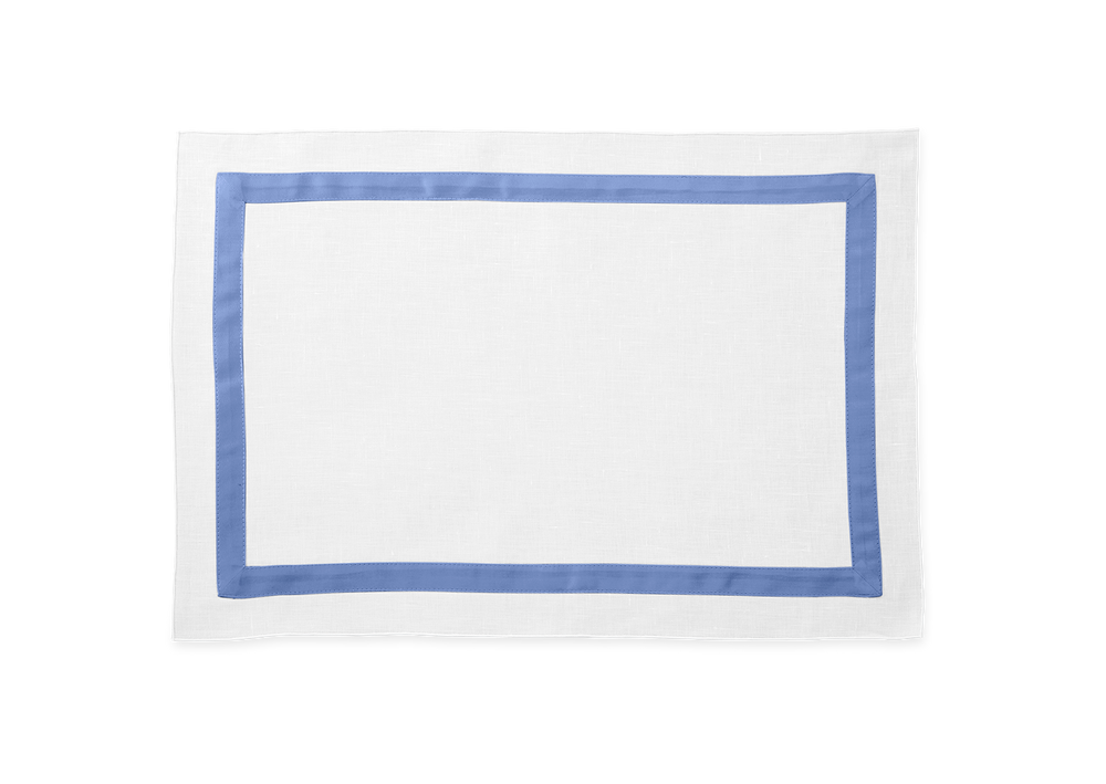 Top-down view of Lowell placemat showcasing white linen with an azure sateen border on white background