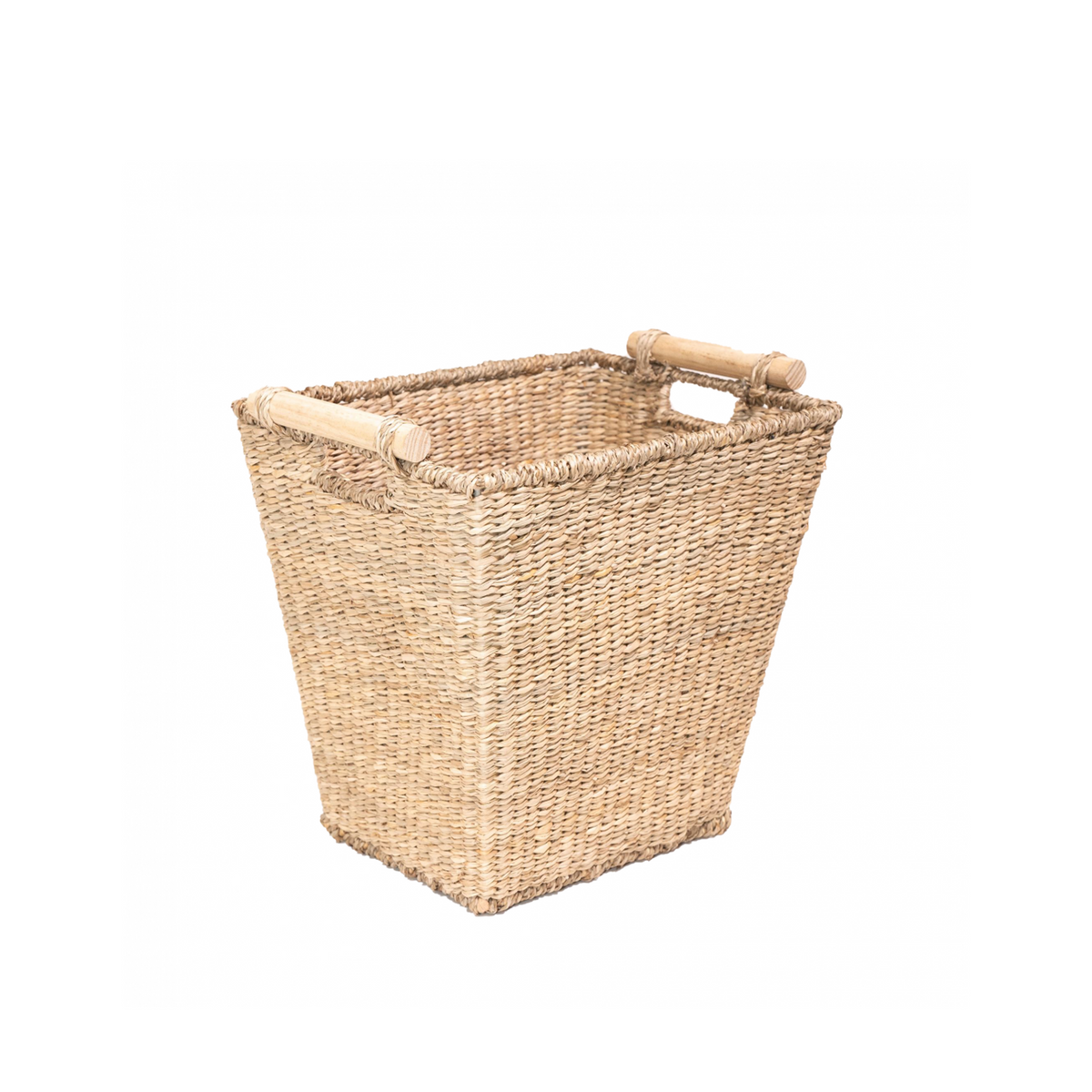 Angled three-quarter view of handwoven seagrass wastepaper basket showcasing tapered square shape and wooden side handles on white background