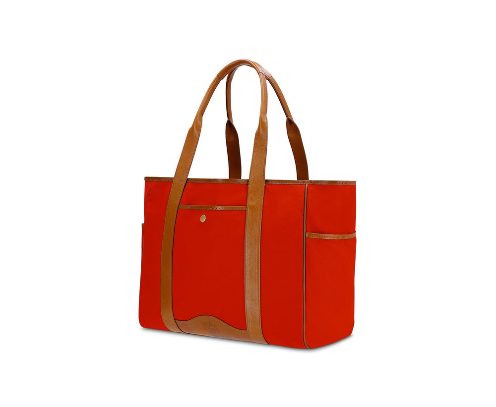 Three-quarter view of Market Tote No. 294 in signal red canvas with vintage tan leather straps and trim on white background