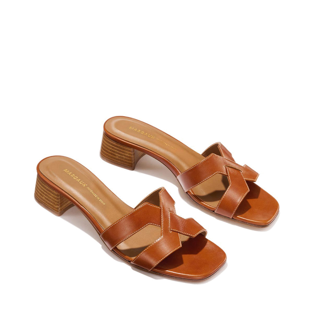 The MX 35 - Saddle Calf by Margaux-development: brown leather sandals with open toes, woven straps, 1.5-inch block heels, and tan insoles.