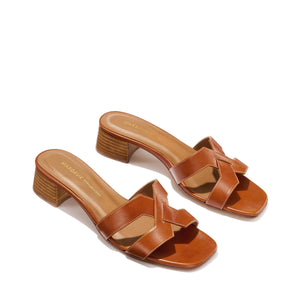 The MX 35 - Saddle Calf by Margaux-development: brown leather sandals with open toes, woven straps, 1.5-inch block heels, and tan insoles.