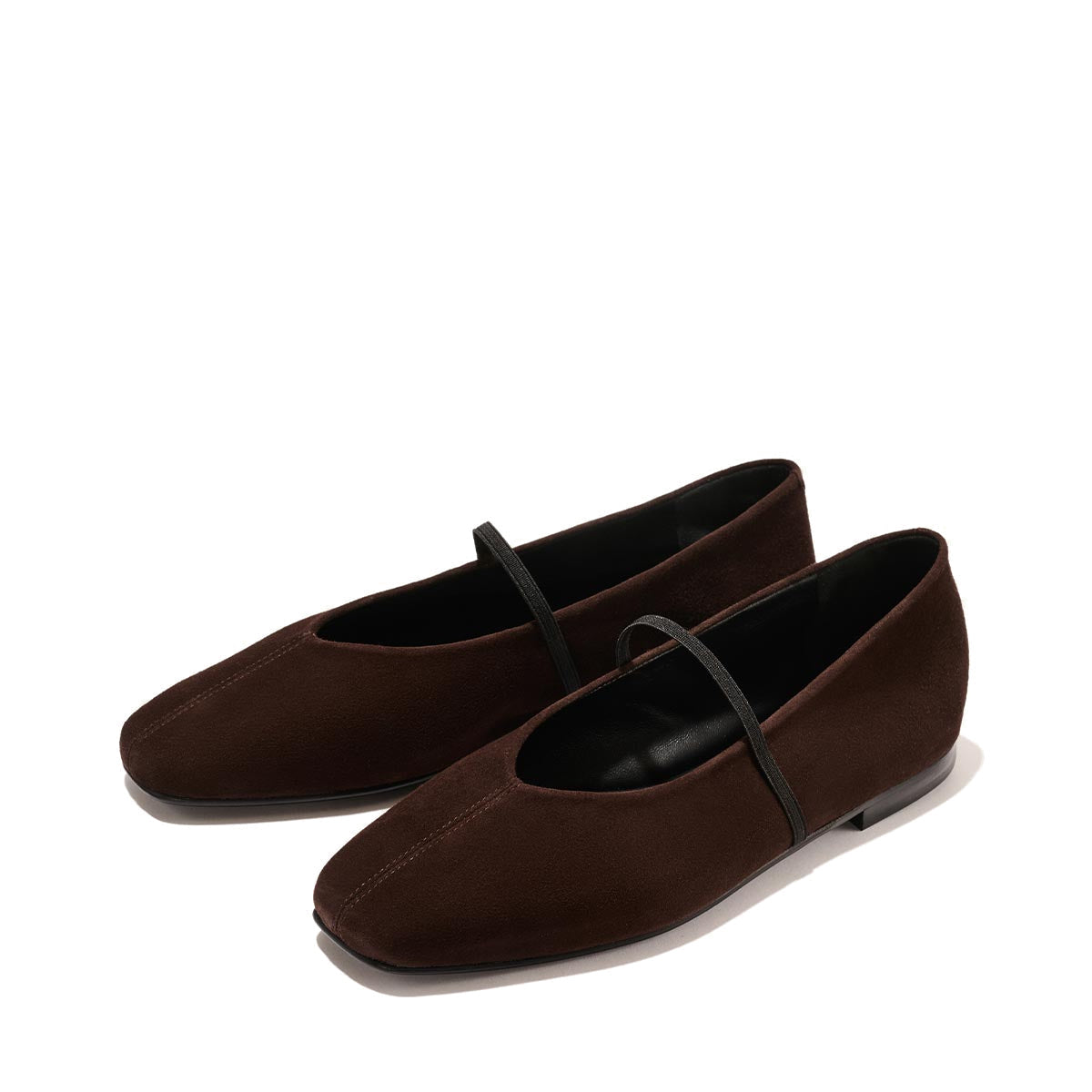 The Phoebe - Espresso Suede by margaux-development: brown suede ballet flats with black soles and a thin black strap, expertly crafted with sacchetto construction for exceptional comfort, shown on a light background.