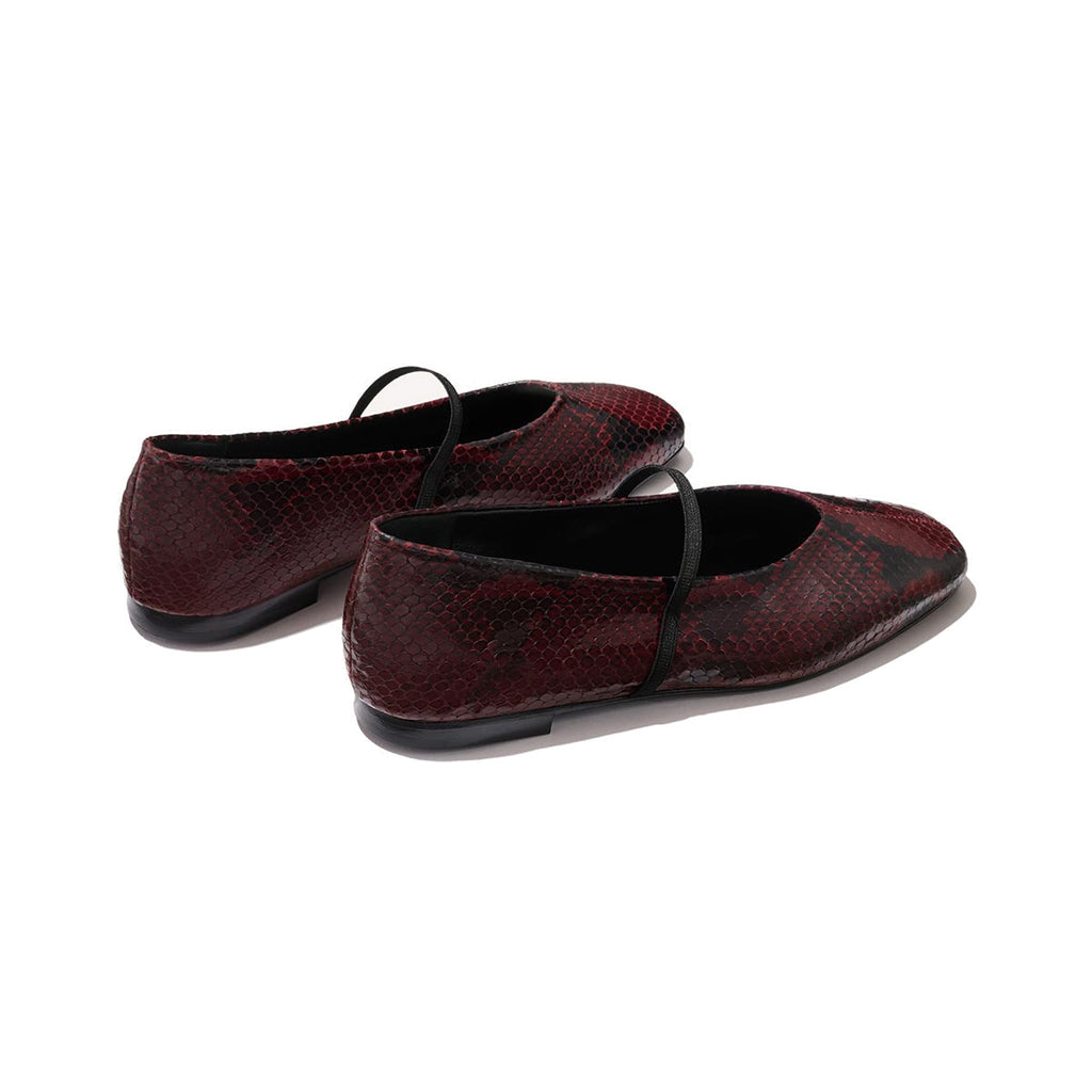 The Phoebe by margaux-development: burgundy python-embossed Mary Jane flats with black straps, sacchetto construction for superior comfort, shown from the back and side on a light background.