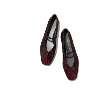 The Phoebe - Burgundy Python Embossed by margaux-development: burgundy and black snakeskin-patterned Mary Jane flats with a single black strap, sacchetto construction for plush comfort, shown on a light beige background.