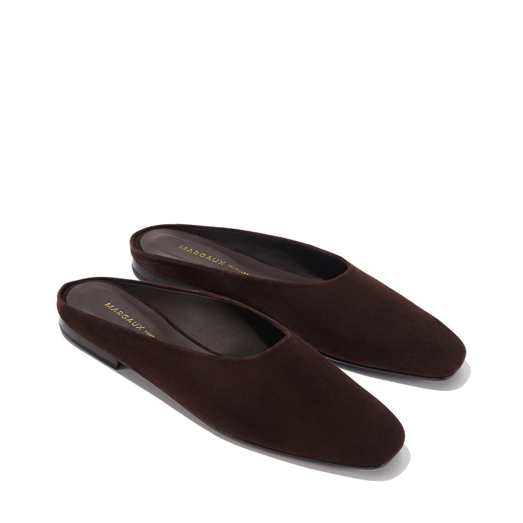 The Clara - Espresso Suede by Margaux: minimalist dark brown suede slip-on loafers with slightly squared toes and a slipper-like silhouette, shown on a neutral background.