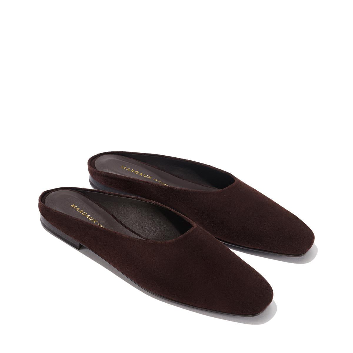 The Clara - Espresso Suede by Margaux: minimalist dark brown suede slip-on loafers with slightly squared toes and a slipper-like silhouette, shown on a neutral background.