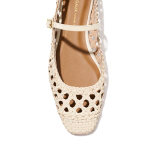 Top view of Margaux’s The Fonteyn Jane in Ecru Woven Leather: a handwoven flat ballerina with closed toe, cutout details, and adjustable ankle strap for a secure fit.