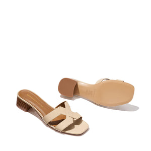 A pair of Margaux’s The MX 35 - Latte Calf open-toe sandals with crisscross straps and low block heels, displayed from the top and bottom on a light background.
