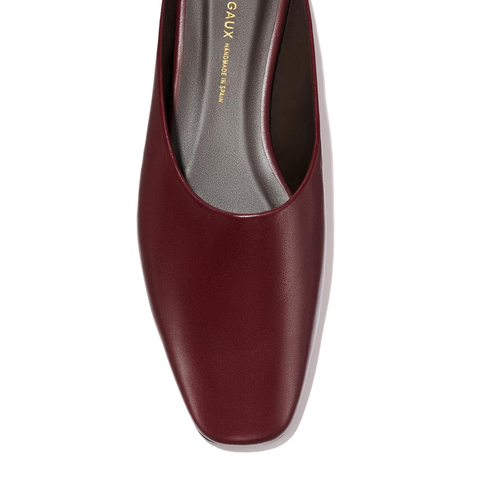 Close-up top view of The Clara - Wine Calf, a do-it-all style flat by Margaux, featuring burgundy leather, a square toe, and a gray insole with gold branding on the inner sole. Set against a plain light-colored background.