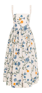Front view of the Mielero Midi Brisa Midi Dress showcasing floral embroidery, pearl accented straps, and softly flared pleated skirt on white background