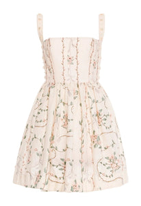 Front view of Mielero Mini Navegante Mini Dress showcasing pearl straps and embroidered floral skirt on white background