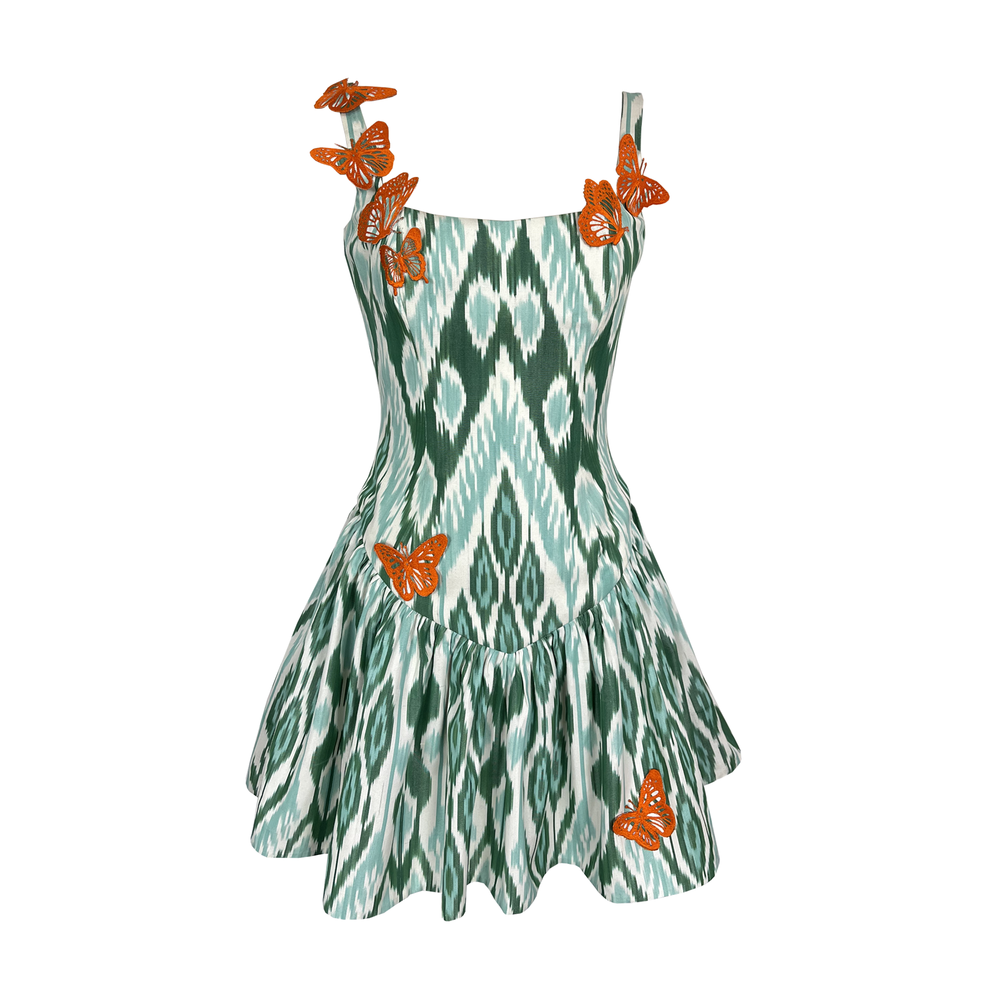 Front view of Mint Mirage dress showing corseted waist, flared mini skirt, green ikat print and orange butterfly appliques