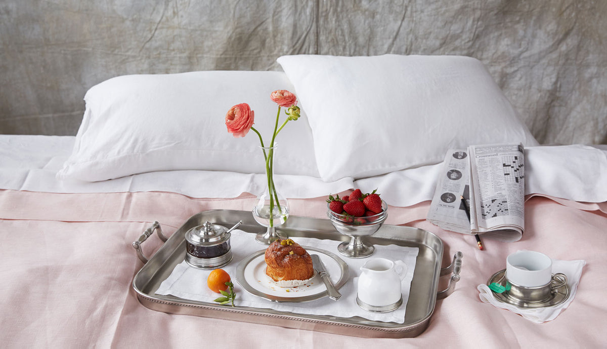 Angled view of Gallery Tray with Handles, Medium showcasing raised edges and side handles with a breakfast setting
