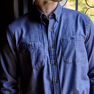 Man wearing the Tom Beckbe Dixon Brushed Cotton Twill Shirt with chest pockets, standing by a sunlit window.