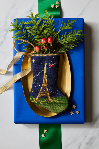 Bonne Nuit Santa in Paris Bauble Stockings displayed with festive decor and holiday greenery