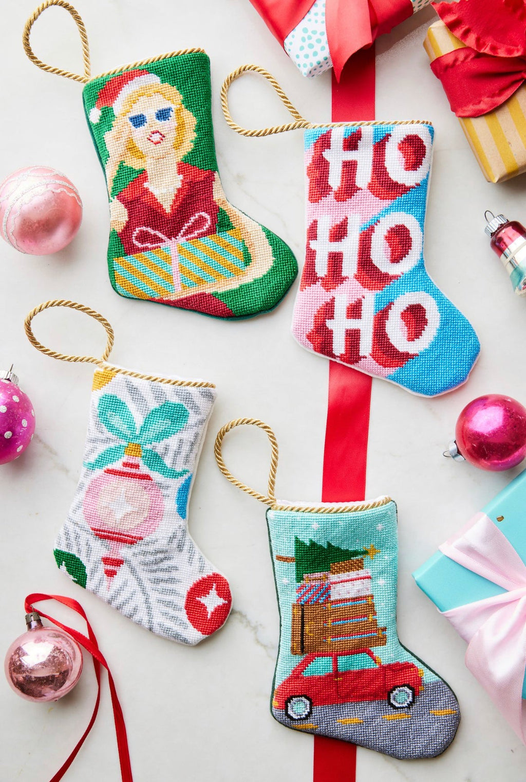 Festive display featuring HO HO HO Bauble Stockings, together with other holiday-themed stockings