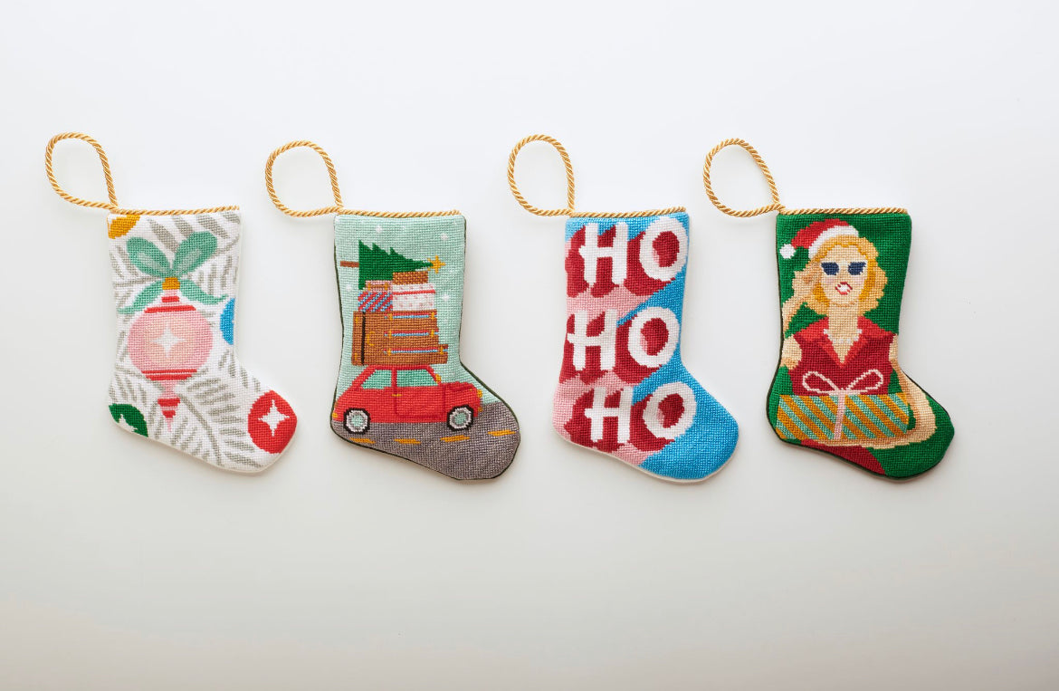 Multiple Holiday-themed Bauble Stockings displayed on white setting