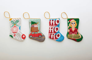 Multiple Holiday-themed Bauble Stockings displayed on white setting