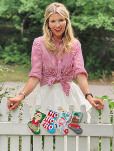 Bauble Stockings featuring stylish HO HO HO design displayed in greenery outdoor holiday setting