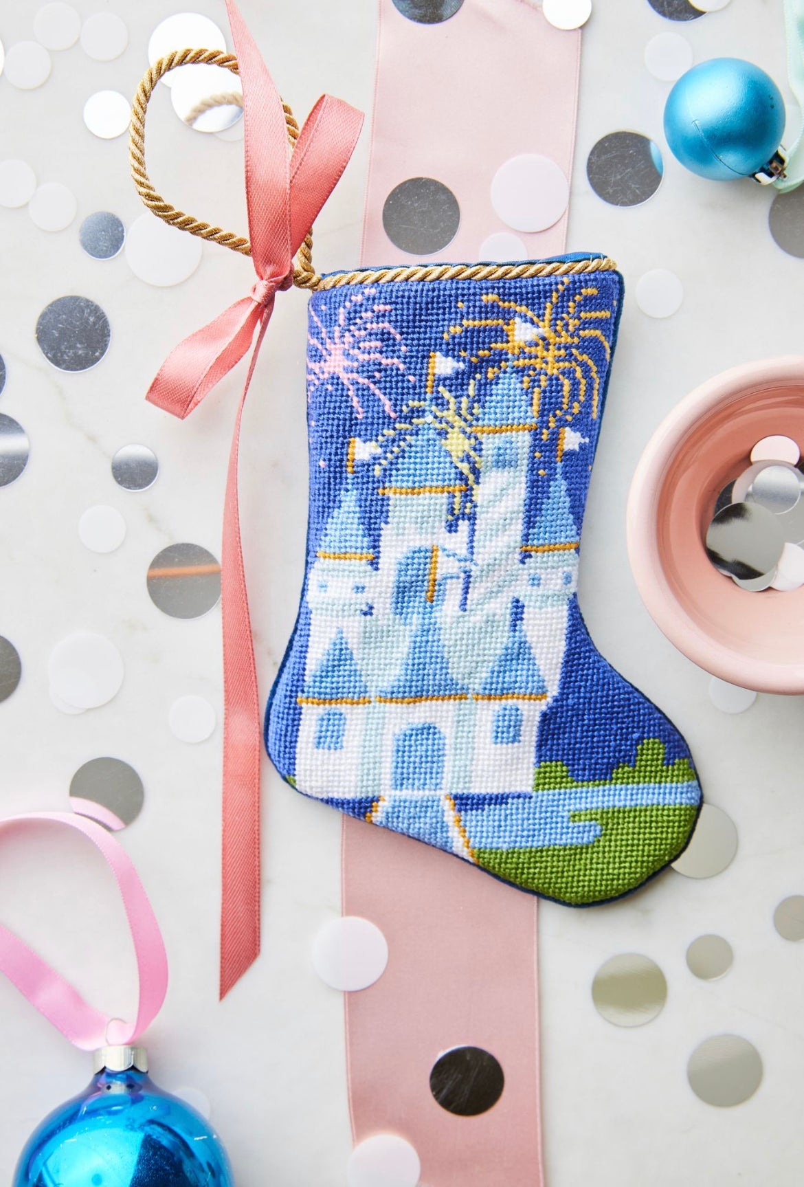 Celebration Castle Bauble Stockings surrounded by vibrant holiday-themed decor.