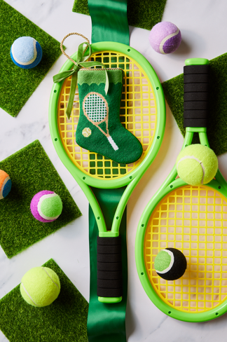 Tennis-themed Bauble Stockings styled with colorful tennis balls, rackets, and green holiday decor