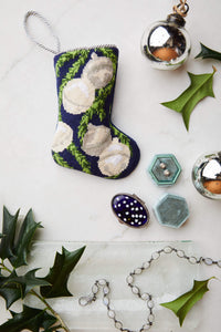 Bauble Stockings styled with silver bell ornaments and evergreen sprigs
