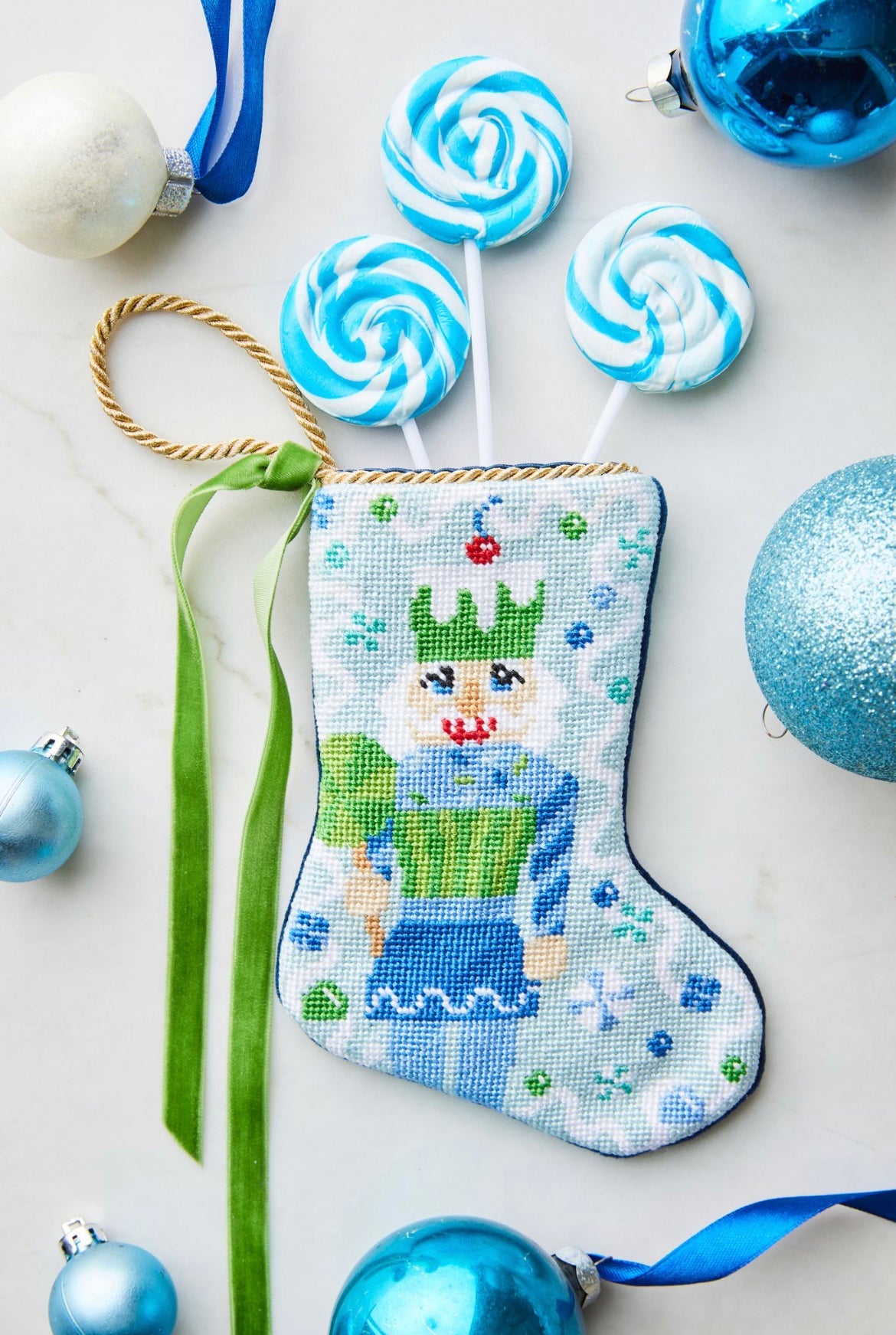 Bauble Stockings styled with colorful candy props and festive blue holiday backdrop