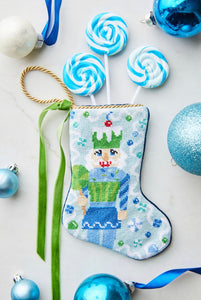 Bauble Stockings styled with colorful candy props and festive blue holiday backdrop