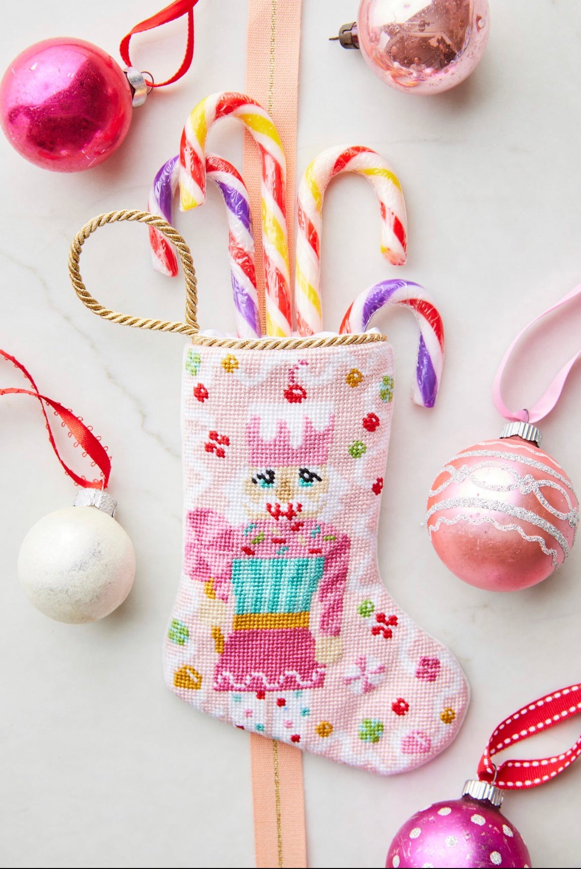 Sugary Sweet Nutcracker Bauble Stockings styled with colorful candy canes and festive backdrop