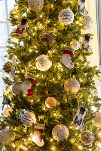 Christmas tree decorated with Bauble Stockings, shimmering ornaments, and twinkling lights
