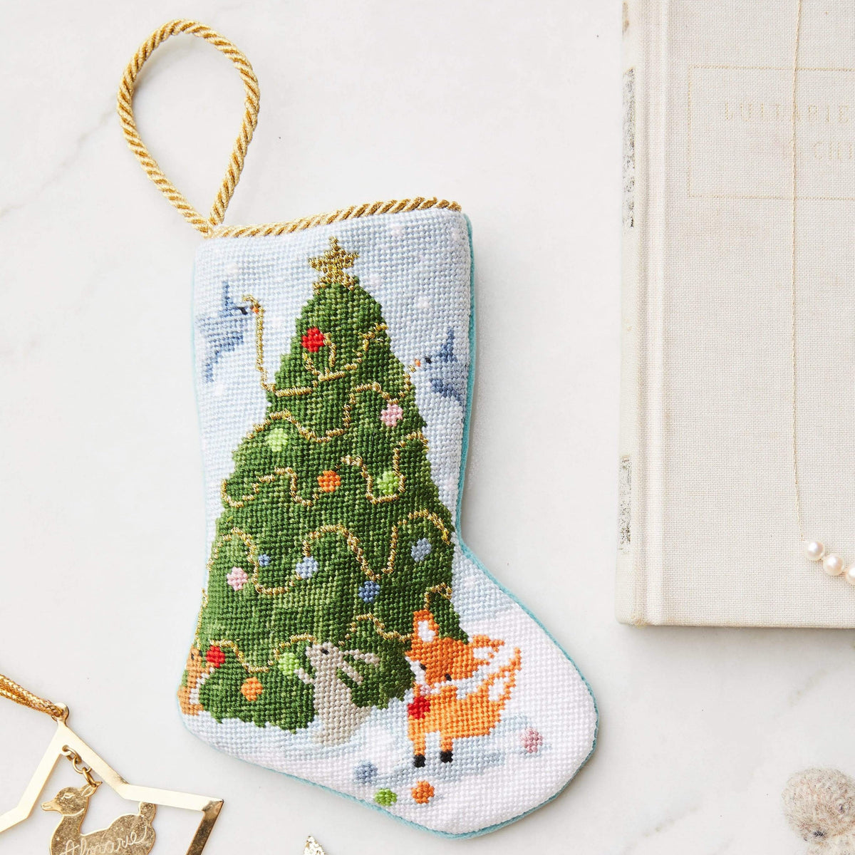 Bauble Stockings styled with plush toy bear and star-shaped decor