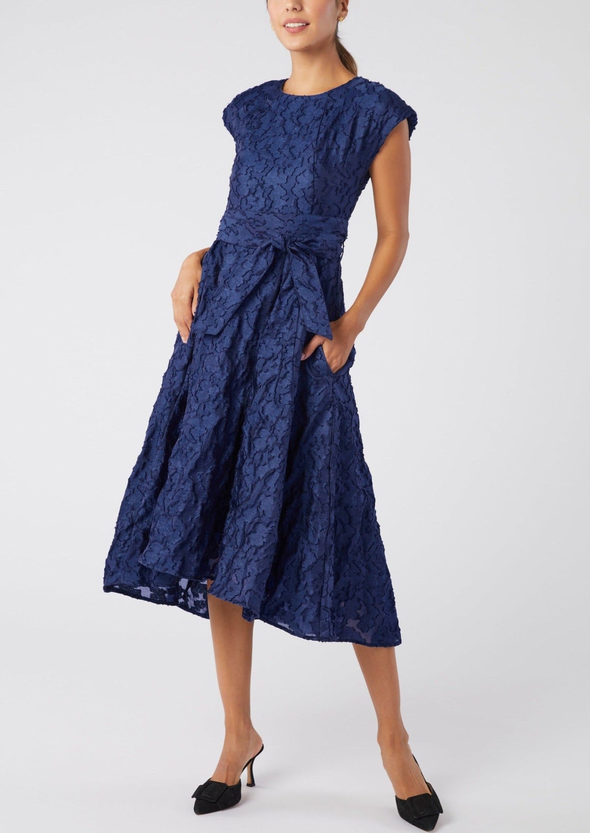 Front view of Olivia Dress in Navy Organza showcasing textured fabric, self belt, pleated waist, and fit and flare silhouette